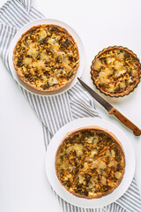 Tree homemade vegetable pie on white background. Rustic food photography. Top view with copy space.