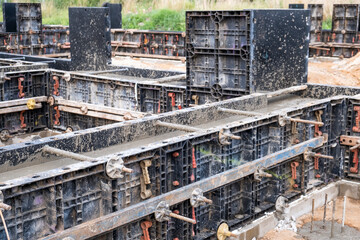 Formwork with metal reinforcement for pouring concrete a solid foundation for a house. Building concept.