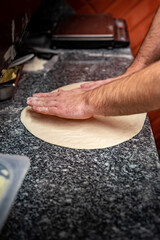 hand of chef baker making pizza at kitchen. The process of making pizza. cooking italian pizza