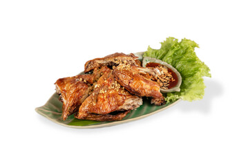 Grilled chicken with fried garlic on plate .