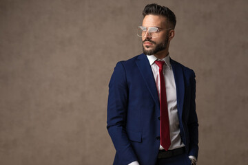 businessman holding one hand in pocket, looking away