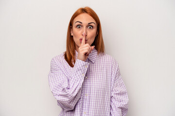 Young caucasian woman isolated on white background keeping a secret or asking for silence.