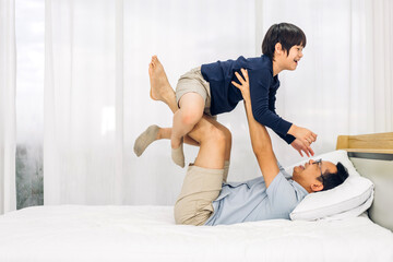 Portrait of enjoy happy love asian family father carrying little asian boy son smiling playing...