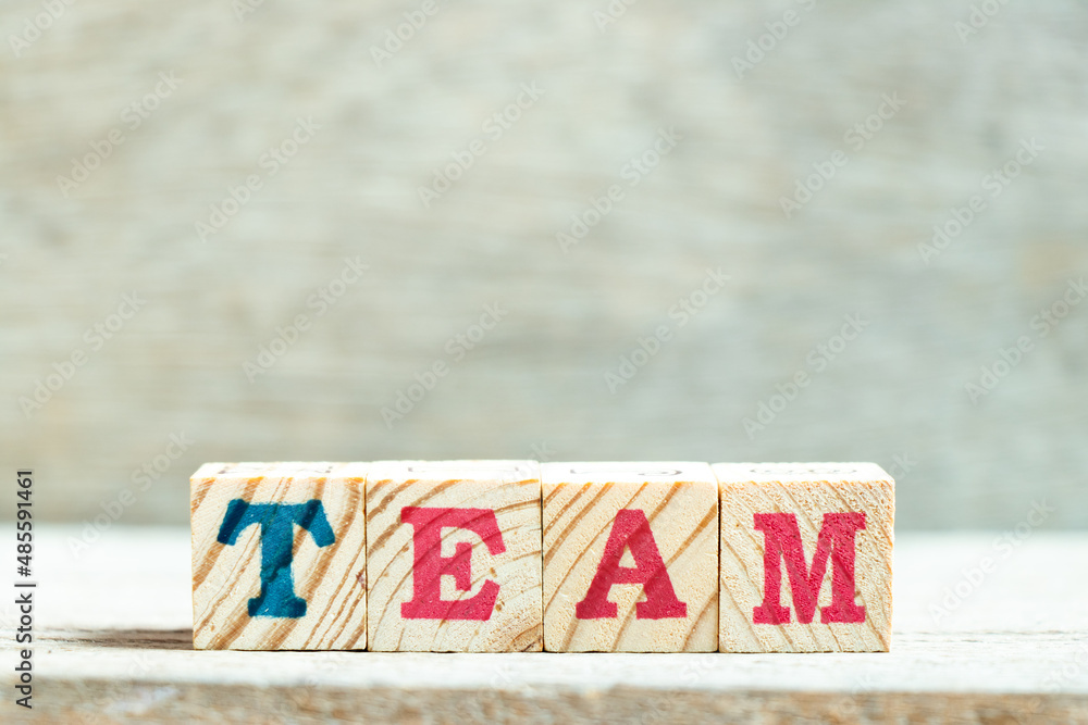 Sticker Alphabet letter block in word team on wood background