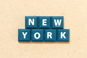 Tile alphabet letter in word new york on wood background