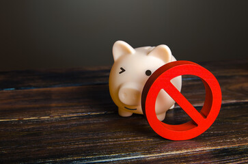 Piggy bank and prohibition sign NO. Bypass restrictions, loopholes in laws. Lifting of sanctions,...