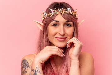 Young caucasian elf woman isolated on pink background