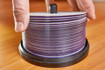 The man folds and counts the disks.