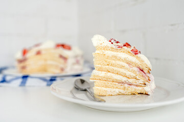 Cake with strawberries and mascarpone on a white wall background. Delicious dessert