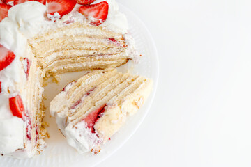 Cake with strawberries and mascarpone on a white wall background. Delicious dessert