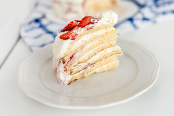 Cake with strawberries and mascarpone on a white wall background. Delicious dessert