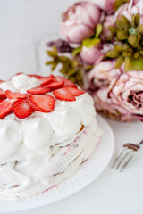 Cake with strawberries and mascarpone on a white wall background. Delicious dessert