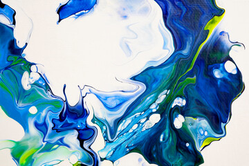 Bright spills of dark blue, blue, yellow colors on a white background. Modern abstract painting. A fragment of a work of art. Abstract colorful painting with liquid acrylic