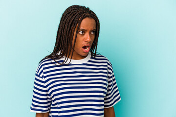 Fototapeta premium Young african american woman isolated on blue background being shocked because of something she has seen.