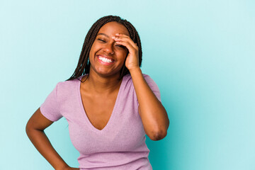 Young african american woman isolated on blue background  joyful laughing a lot. Happiness concept.