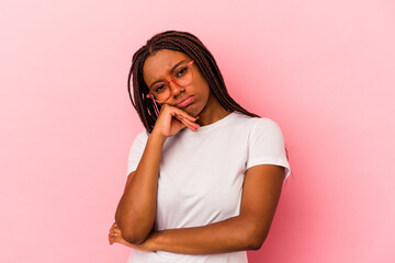 Young african american woman isolated on pink background  tired of a repetitive task.