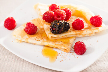 pancakes with raspberries, blackberries and honey