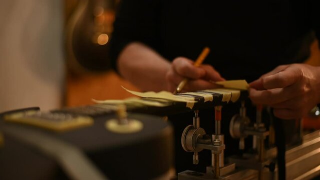 Guitar in repair service shop with a hands of a guitar luthier