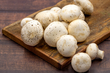 Organic mushrooms on a wooden background. Cultivated mushroom or portabello mushroom