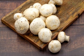 Organic mushrooms on a wooden background. Cultivated mushroom or portabello mushroom