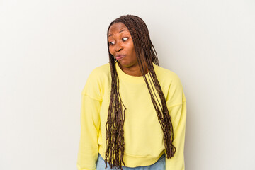 Young african american woman isolated on white background shrugs shoulders and open eyes confused.