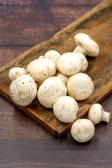 Organic mushrooms on a wooden background. Cultivated mushroom or portabello mushroom