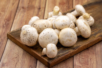 Organic mushrooms on a wooden background. Cultivated mushroom or portabello mushroom