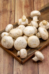 Organic mushrooms on a wooden background. Cultivated mushroom or portabello mushroom