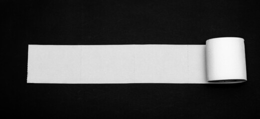 toilet paper on a black background place for an inscription