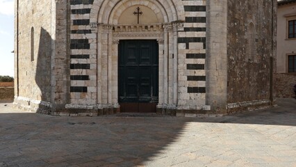 The entrance door to the Baptistery of San Giovanni in the historic center of Volterra, Diocese of Volterra in Tuscany, Italy.