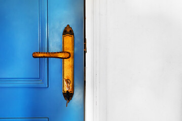 Blue front door with gilded lock and handle.