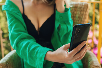 Woman in lingerie doing selfie via smartphone.