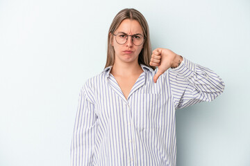 Young caucasian woman isolated on blue background showing thumb down, disappointment concept.