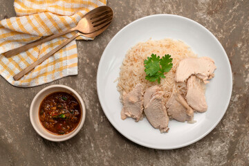 Asian healthy food chicken rice steam on brown background.