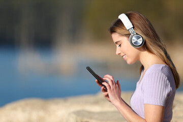 Profile of happy teen listening to music in nature