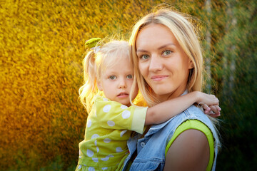 Happy family in the summer sunny rain. Portrait of Mother and daughter outdoors