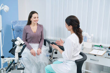 Focused young woman having consultation with gynecologist