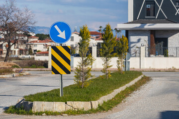 Close-up road sign detour on the right against the background of the road