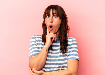 Young Argentinian woman isolated on pink background having some great idea, concept of creativity.