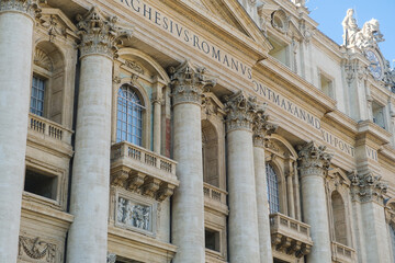 Low angle view of exterior and entrance of Saint Peter's Basilica.