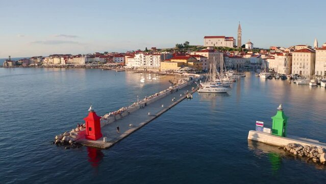 Picturesque summer scene of Slovenia Adriatic coast with beautiful Venetian architecture. Amazing morning cityscape of Piran town. View from flying drone of old port. 4K video (Ultra High Definition).