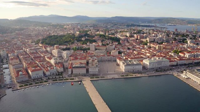 4k drone flight back footage (Ultra High Definition) of Trieste city, Italy, Europe. Splendid morning seascape of Adriatic sea. Traveling concept background..