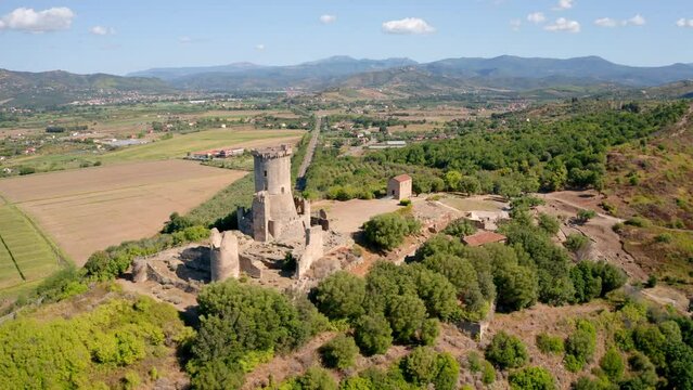 4k drone flight moving to the side footage (Ultra High Definition) of historical landmark - Velia Tower. Aerial morning scene of Parco Archeologico di Velia, Italy. Traveling concept background.