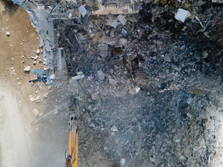 Excavator with Hydraulic Shears in action, building demolition