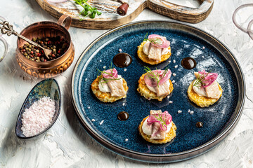 Potato pancakes with sour cream, herring fillets and purple onions, Crispy potato pancakes, Delicious breakfast or snack, Clean eating, dieting, vegan food concept. top view