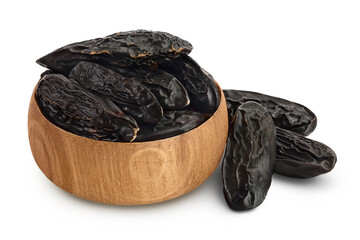 Tonka bean in wooden bowl isolated on white background with clipping path and full depth of field. Bean of Dipteryx odorata