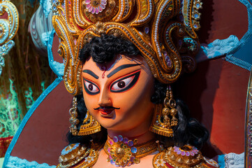 God Kartik idol, during Durga Puja festival at night. Shot under colored light at Howrah, West Bengal, India. Biggest festival of Hinduism , celebrated all over the world.