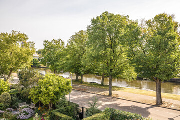 Cottage garden and river flowing in town