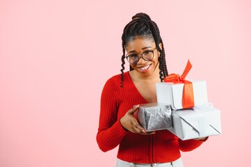 Photo of cheerful positive girl hold gift package isolated pink color background.