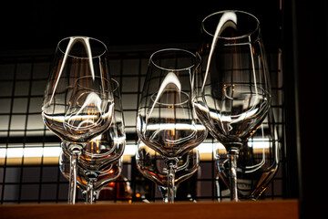 Fototapeta na wymiar Different empty clean glasses on counter in bar